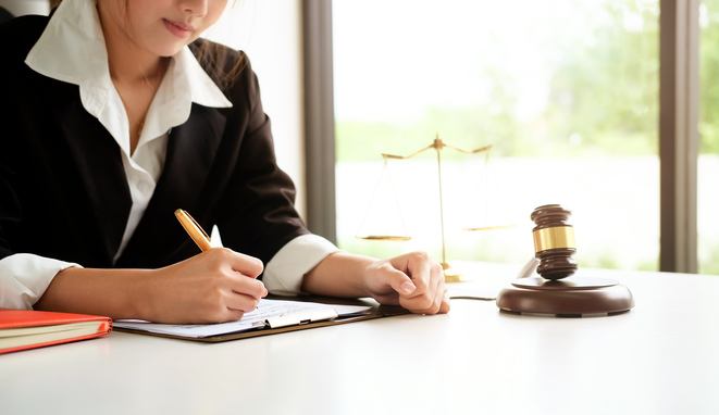 Lawyer woman working on workplace with window light at morning time.
