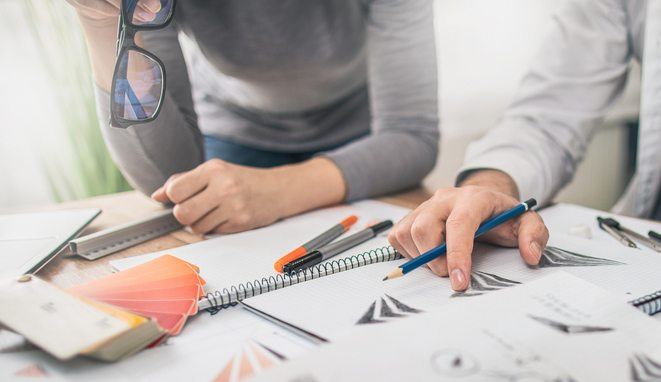 Graphic designer drawing sketches logo design.