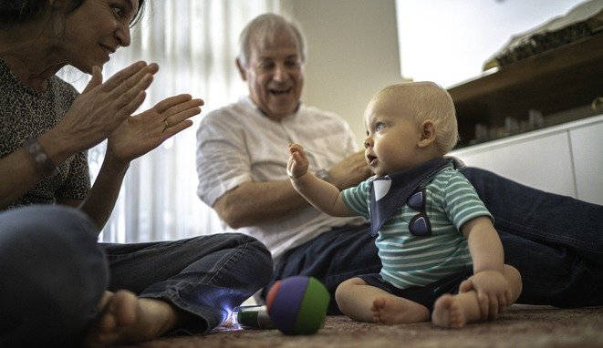 Grandparents playing with grandson