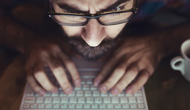 Computer hacker stealing information with laptop