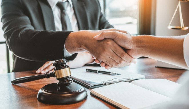 Businessman shaking hands to seal a deal Judges male lawyers Consultation legal services Consulting in regard to the various contracts to plan the case in court.
