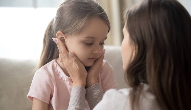 Madre acariciando la cara de su hija